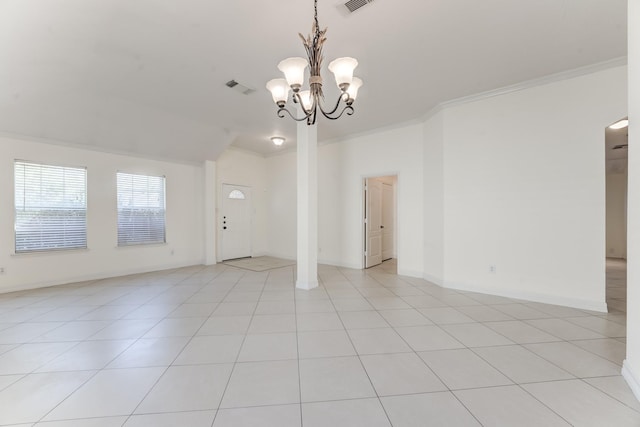 tiled empty room featuring ornamental molding and a chandelier