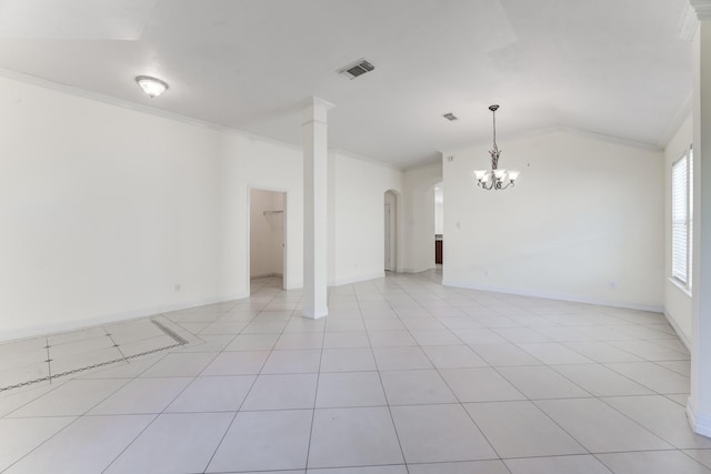 empty room with lofted ceiling, light tile patterned floors, crown molding, a chandelier, and ornate columns