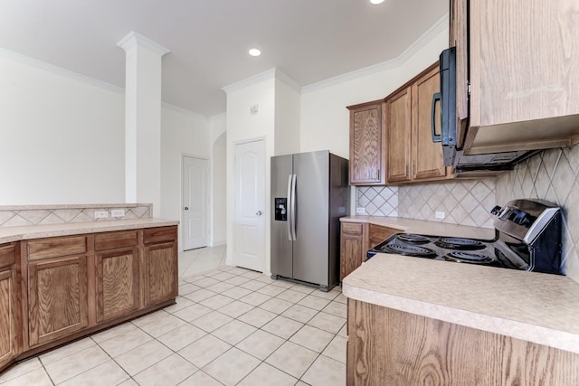 kitchen with tasteful backsplash, crown molding, appliances with stainless steel finishes, and light tile patterned floors