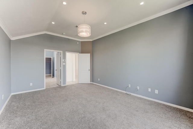 unfurnished bedroom with light carpet, crown molding, vaulted ceiling, and a walk in closet