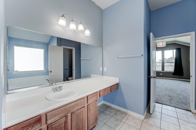 bathroom with vanity, tile patterned floors, toilet, and a bathing tub