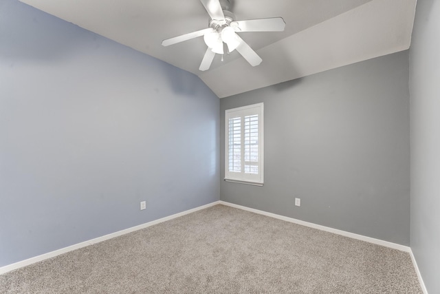 spare room with ceiling fan, lofted ceiling, and carpet floors