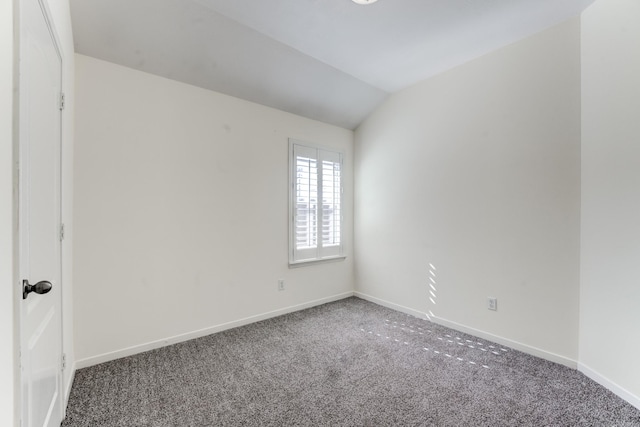 spare room with lofted ceiling and carpet