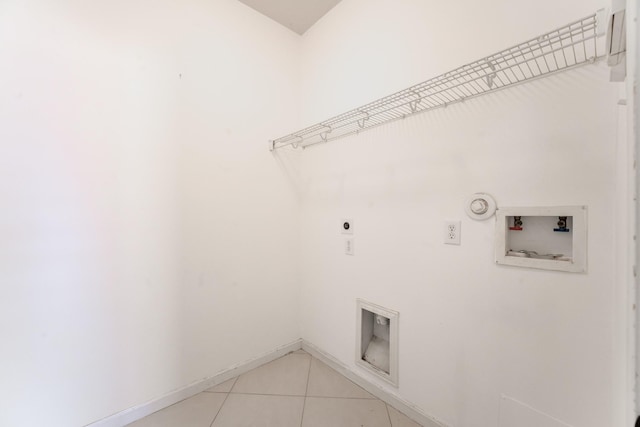 clothes washing area featuring hookup for an electric dryer, hookup for a gas dryer, hookup for a washing machine, and light tile patterned floors