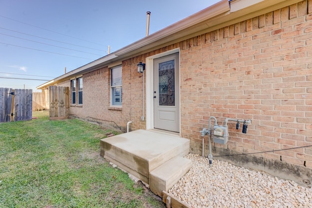 doorway to property with a yard