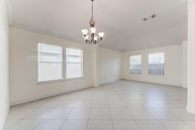 tiled empty room featuring ornamental molding, a healthy amount of sunlight, and a notable chandelier