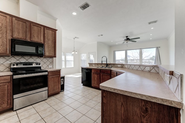 kitchen featuring a healthy amount of sunlight, sink, decorative backsplash, and black appliances