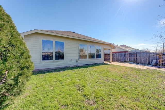 rear view of house with a yard