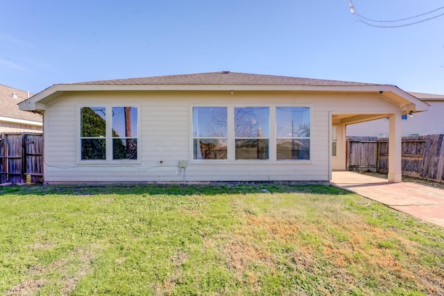 back of property featuring a lawn and a patio