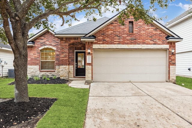 view of front property featuring cooling unit, a garage, and a front lawn