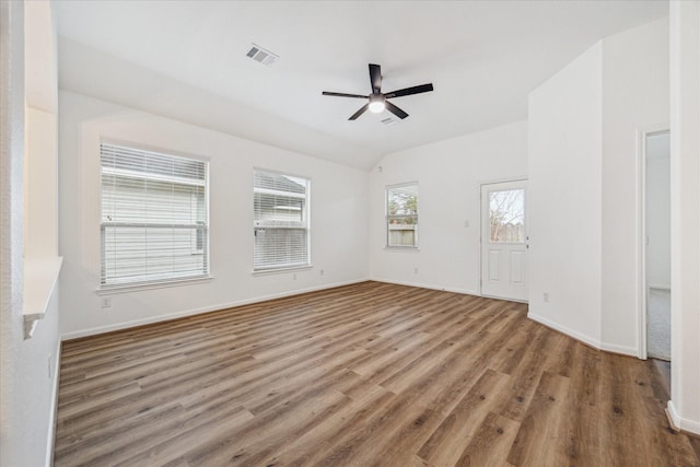 spare room with hardwood / wood-style floors, vaulted ceiling, and ceiling fan