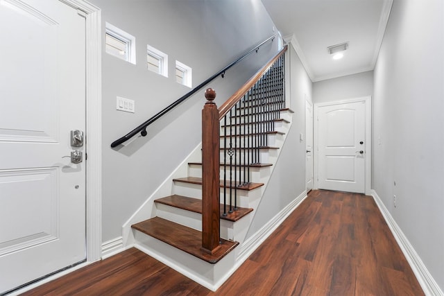 staircase featuring crown molding and wood-type flooring