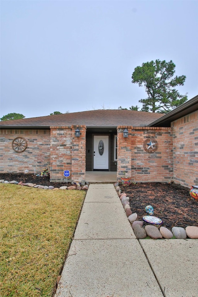 doorway to property with a lawn