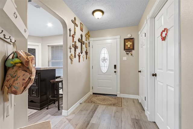 entrance foyer featuring a textured ceiling and light hardwood / wood-style flooring