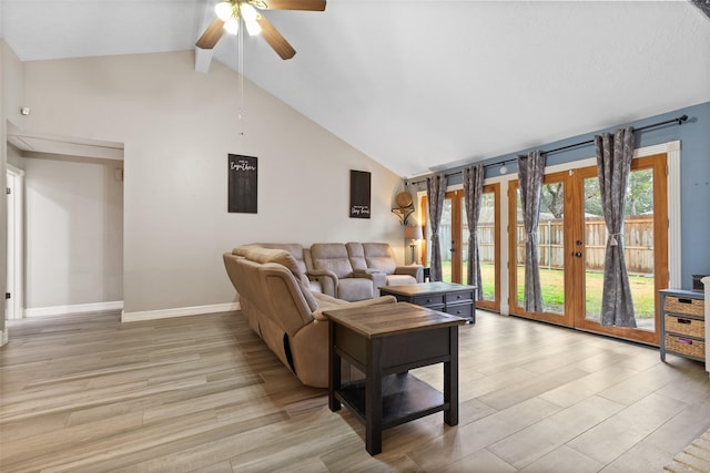 living room with french doors, ceiling fan, light hardwood / wood-style floors, and lofted ceiling with beams