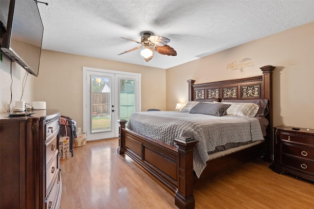 bedroom with access to exterior, a textured ceiling, ceiling fan, and light wood-type flooring