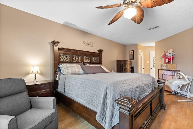 bedroom with ceiling fan and light hardwood / wood-style flooring