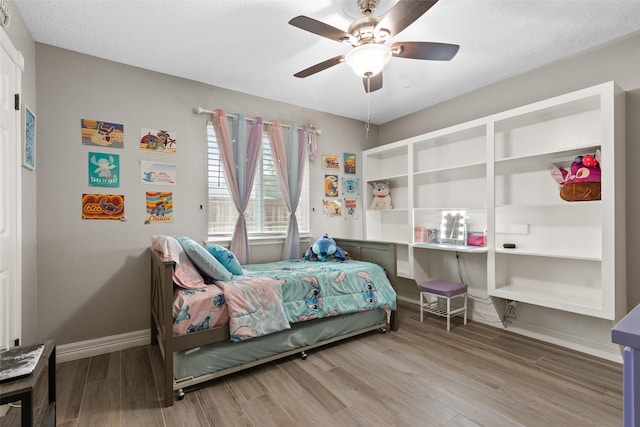 bedroom featuring hardwood / wood-style flooring and ceiling fan