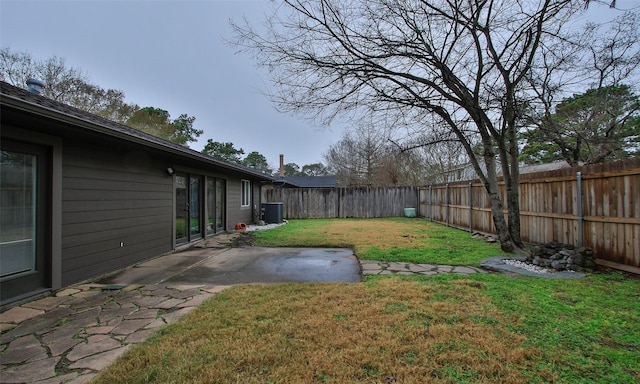 view of yard featuring cooling unit and a patio area