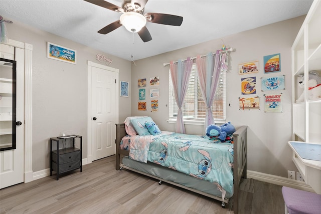 bedroom with ceiling fan and light hardwood / wood-style floors