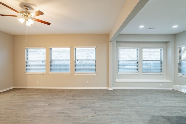 empty room featuring ceiling fan and light hardwood / wood-style floors