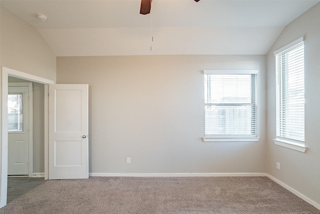 carpeted empty room featuring vaulted ceiling and ceiling fan