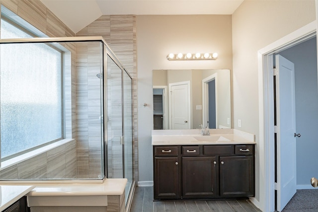 bathroom featuring vanity, an enclosed shower, and vaulted ceiling