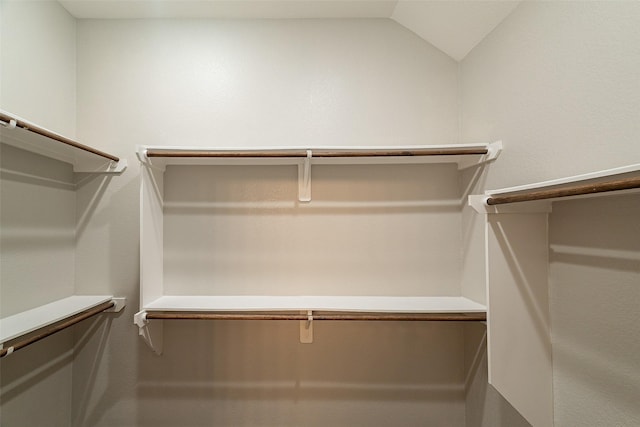 walk in closet with vaulted ceiling