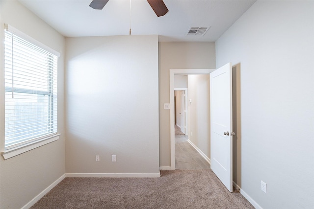 carpeted empty room featuring ceiling fan