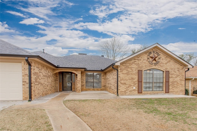 view of front facade with a garage and a front lawn