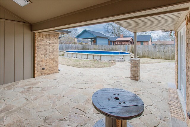 view of patio / terrace with a fenced in pool