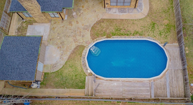 view of pool featuring a yard