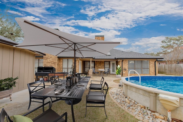 view of pool featuring a hot tub, a patio, and area for grilling