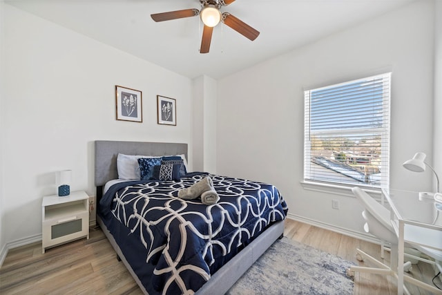 bedroom with wood-type flooring and ceiling fan