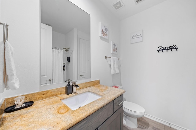 bathroom featuring vanity, a shower with shower curtain, and toilet