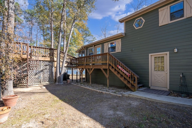 rear view of house featuring a wooden deck