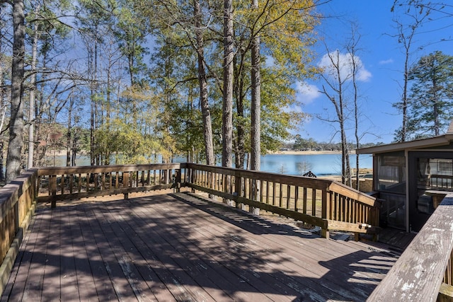 deck with a water view and a sunroom