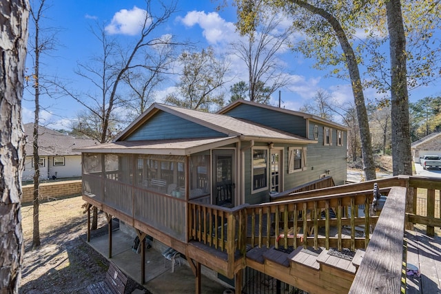 back of house featuring a sunroom