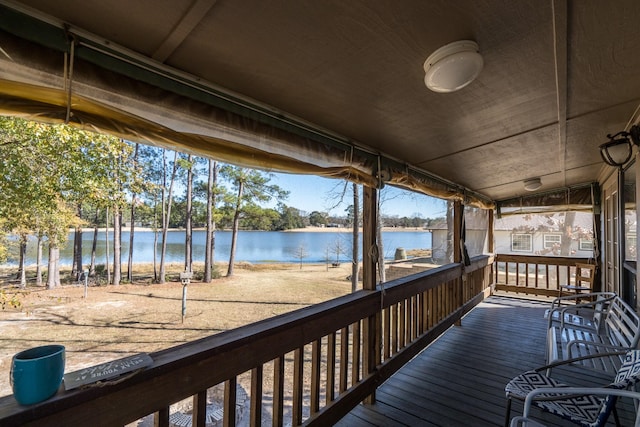 wooden terrace featuring a water view