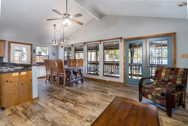 dining space featuring ceiling fan, high vaulted ceiling, beam ceiling, and hardwood / wood-style floors