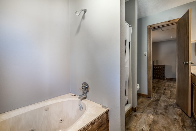 bathroom featuring vanity, wood-type flooring, independent shower and bath, and a textured ceiling