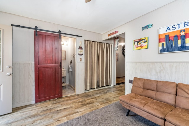 living room featuring a barn door and hardwood / wood-style floors