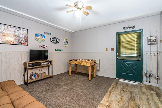 playroom featuring heating unit, carpet floors, and ceiling fan