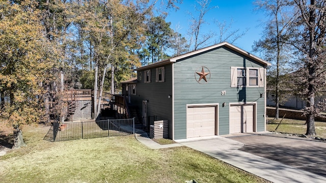 view of home's exterior with a wooden deck, a garage, and a lawn