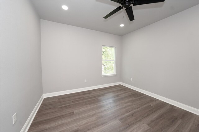 unfurnished room with ceiling fan and dark hardwood / wood-style flooring