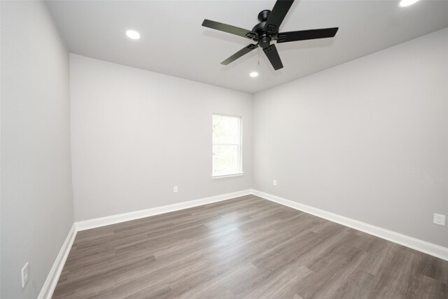 unfurnished room with ceiling fan and wood-type flooring