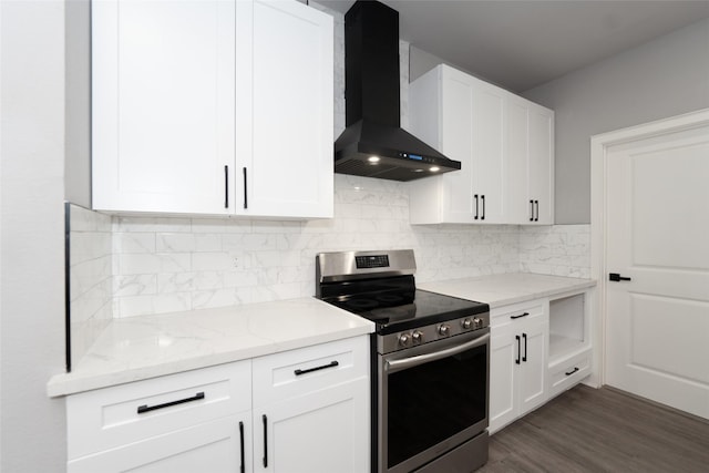 kitchen featuring white cabinets, decorative backsplash, stainless steel range with electric stovetop, light stone counters, and wall chimney range hood