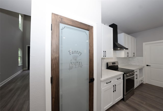 kitchen featuring white cabinets, backsplash, dark hardwood / wood-style flooring, electric range, and wall chimney exhaust hood