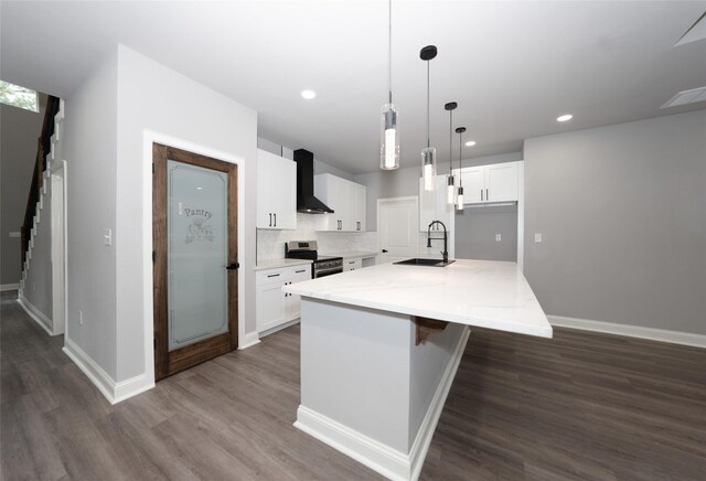 kitchen featuring wall chimney range hood, sink, stainless steel electric range, and white cabinets