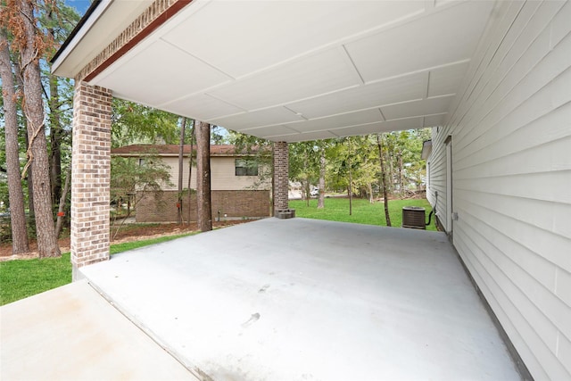 view of patio / terrace with a carport and central AC unit